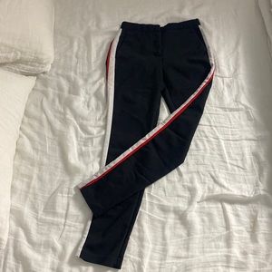 Skinny black pants with red and white trim detail